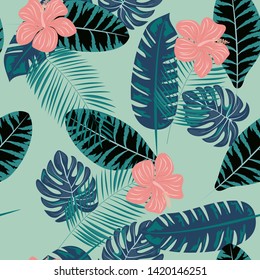 Tropical flowers and leaves of plants jungle vector seamless pattern. Exotic floral print for swimsuits, fabrics, wallpapers. Floral background with ethnic leaves and flowers.