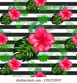 Tropical flowers and palm leaves on background. Seamless pattern