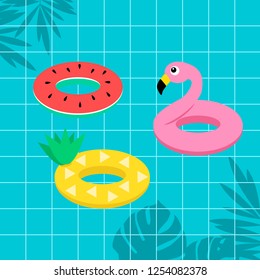 Tropical fruit watermelon pineapple and flamingo life ring on blue swimming pool background
