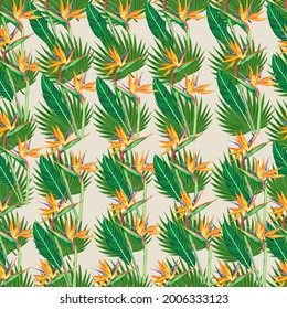 Tropical leaves and flowers seamless pattern. Jungle exotic strelitzia and leaf on light shade of yellow background.