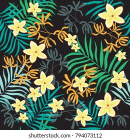 Tropical leaves and tropical flowers seamless pattern on a black background