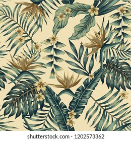 Tropical leaves and gold flowers seamless  cheerful pattern wallpaper of palm trees and bird of paradise (strelitzia) plumeria on a beige background