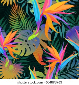 Tropical leaves and paradise flowers in night jungle. Seamless exotic detailed botanical pattern. Vector colorful trendy background.