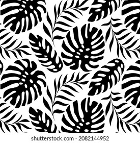 Tropical leaves pattern, vector illustration in black and white.   fashionable jangle print for different uses. isolated silhouettes. 