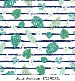 Tropical leaves scattered on the striped background