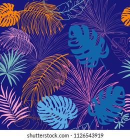 tropical leaves silhouette seamless pattern on a blue background