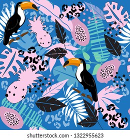 Tropical leaves, toucan and papaya on a blue background seamless pattern