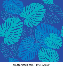 Tropical monstera leaves seamless pattern on blue background