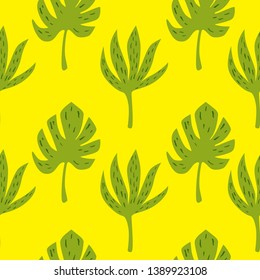 Tropical palm and jungle green leaves. Seamless background for fabric, wallpaper and textile. Vector isolated hand drawn elements on the yellow background.