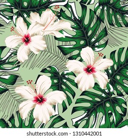 Tropical palm leaves, white hibiscus flowers, green background. Vector seamless pattern. Jungle foliage illustration. Exotic plants. Summer beach floral design. Paradise nature