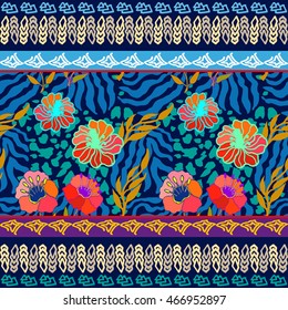 Tropical paradise seamless pattern. Animal print with palm leaves and exotic flowers, bohemian borders. Ethnic textile collection. Colorful on blue.