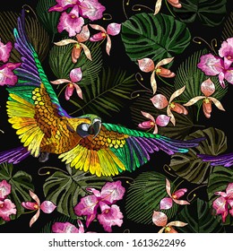 Tropical parrots, orchids flowers and palm leaves seamless pattern. Jungle paradise background. Macaws. Fashionable template for design of clothes, textiles 