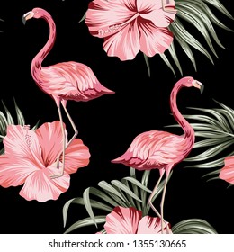 Tropical pink hibiscus and flamingo floral green palm leaves seamless pattern black background. Exotic jungle wallpaper. 