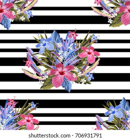 Tropical seamless floral pattern with exotic leaves and hibiscus flowers on  striped black and white background. Flower design for printing on fabric, clothing, home textiles, wallpaper, gift wrapping