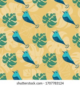 Tropical seamless pattern with blue birds and leaves on yellow background
