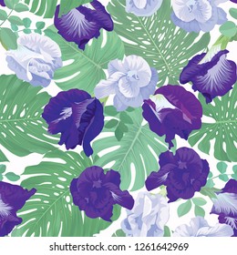 Tropical seamless pattern with butterfly pea flowers and green leaves background. Vector set of exotic tropical garden for holiday invitations, greeting card and fashion design.