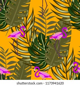 Tropical seamless pattern with flamingos and tropical leaves. Leaves of palm, monstera and banana. Summer background with flamingos.