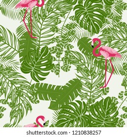 Tropical seamless pattern with flamingos and tropical leaves. Leaves of palm, monstera and banana. Summer background with flamingos.