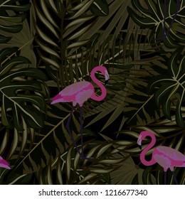Tropical seamless pattern with flamingos and tropical leaves. Leaves of palm, monstera and banana. Summer background with flamingos.