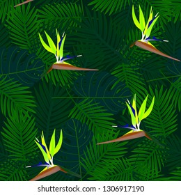 Tropical seamless pattern of flowers bird of Paradise (strelitzia) on the background of palm leaves. Exotic illustration of jungle plants.