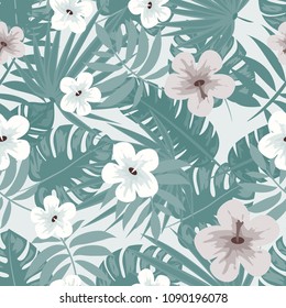 Tropical seamless pattern with flowers and leaves in a green color.