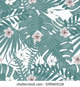 Tropical seamless pattern with flowers and leaves in a green color.