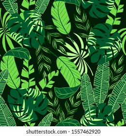 Tropical seamless pattern with green leaves and plants on a dark background. Vector background for various surface. Floral pattern. Jungle leaves. Exotic wallpaper, Hawaiian style.