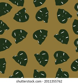 Tropical seamless pattern with green  leaves on mustard color background. Tropical vector background for print or textile.