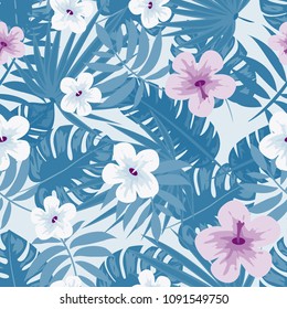 Tropical seamless pattern with leaves of blue and flowers. Background with hibiscus, palm. Jungle.
