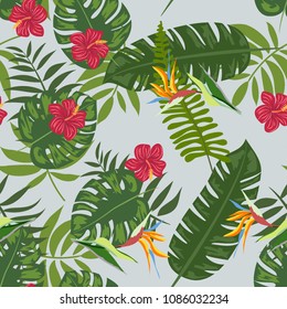 Tropical seamless pattern with leaves of a palm tree, flowers of strelitzia and hibiscus.