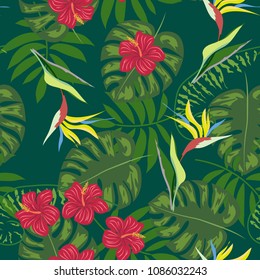 Tropical seamless pattern with leaves of a palm tree, flowers of strelitzia and hibiscus.