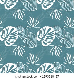 Tropical seamless pattern with leaves. White tropical leaves on blue background.
