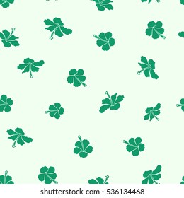 Tropical seamless pattern with many green and neutral hibiscus flowers. Green and neutral vector seamless pattern. Vector illustration.