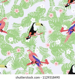 Tropical seamless pattern with a parrot, toucan and tropical flowers and leaves.