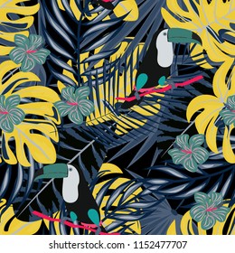 Tropical seamless pattern with a parrot, toucan and tropical flowers and leaves.