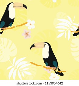 Tropical seamless pattern with a parrot, toucan and tropical flowers and leaves.