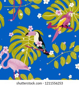 Tropical seamless pattern with a parrot, toucan, flamingo and tropical flowers and leaves.