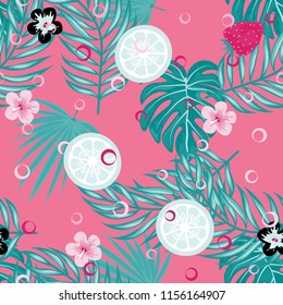 Tropical seamless pattern with strawberries, lemon, lime and tropical leaves. Bright fruit pattern with tropics. Background with fruits.