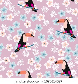 Tropical seamless pattern with toucan, flowers and leaves. Beautiful background with tropical leaves and flowers. Birds of the jungle. For covers, paper, wallpaper and fabric.