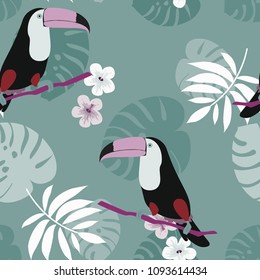 Tropical seamless pattern with toucan, flowers and leaves. Beautiful background with tropical leaves and flowers. Birds of the jungle. For covers, paper, wallpaper and fabric.