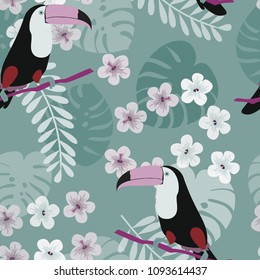 Tropical seamless pattern with toucan, flowers and leaves. Beautiful background with tropical leaves and flowers. Birds of the jungle. For covers, paper, wallpaper and fabric.