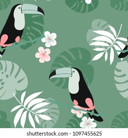 Tropical seamless pattern with toucan, flowers and leaves. Beautiful background with tropical leaves and flowers. Birds of the jungle. For covers, paper, wallpaper and fabric.