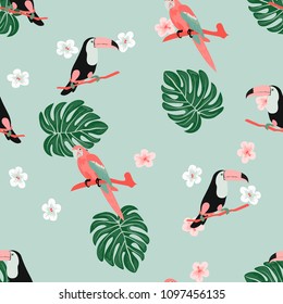 Tropical seamless pattern with toucan, flowers and leaves. Beautiful background with tropical leaves and flowers. Birds of the jungle. For covers, paper, wallpaper and fabric.