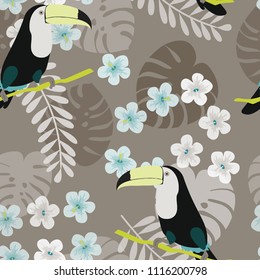 Tropical seamless pattern with toucan, flowers and leaves. A tropical forest with birds. Stylish tropical background with toucan.