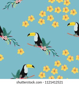 Tropical seamless pattern with toucan, flowers and leaves. Beautiful background with tropical leaves and flowers. Birds of the jungle. For covers, paper, wallpaper and fabric.