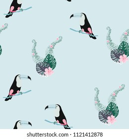 Tropical seamless pattern with toucan, flowers and leaves. Beautiful background with tropical leaves and flowers. Birds of the jungle. For covers, paper, wallpaper and fabric.