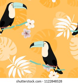 Tropical seamless pattern with toucan, flowers and leaves. Beautiful background with tropical leaves and flowers. Birds of the jungle. For covers, paper, wallpaper and fabric.