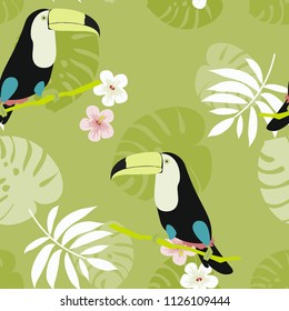 Tropical seamless pattern with toucan, flowers and leaves. A tropical forest with birds. Stylish tropical background with toucan.