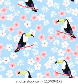 Tropical seamless pattern with toucan, flowers and leaves. A tropical forest with birds. Stylish tropical background with toucan.
