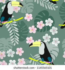 Tropical seamless pattern with toucan, flowers and leaves. A tropical forest with birds. Stylish tropical background with toucan.